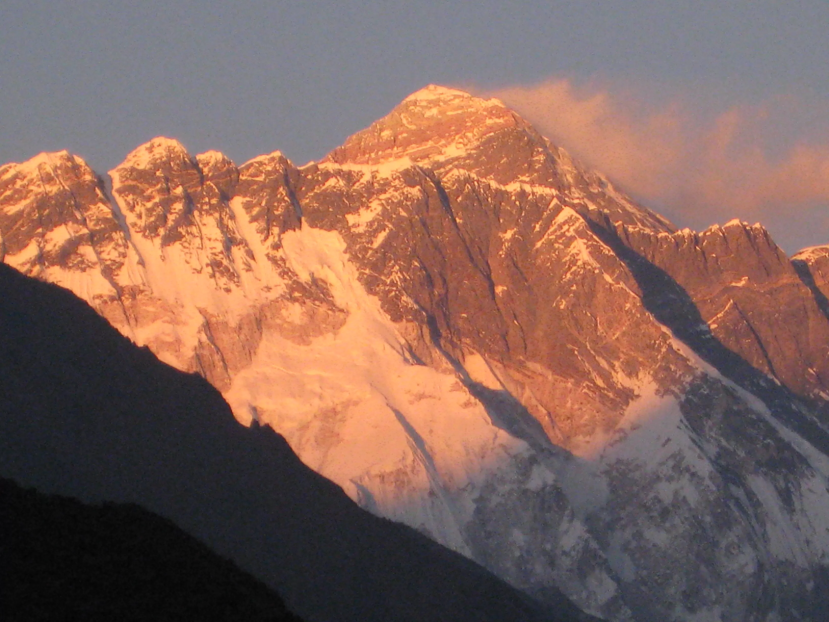 Climbers reaching the summit of Mount Everest with panoramic Himalayan views
