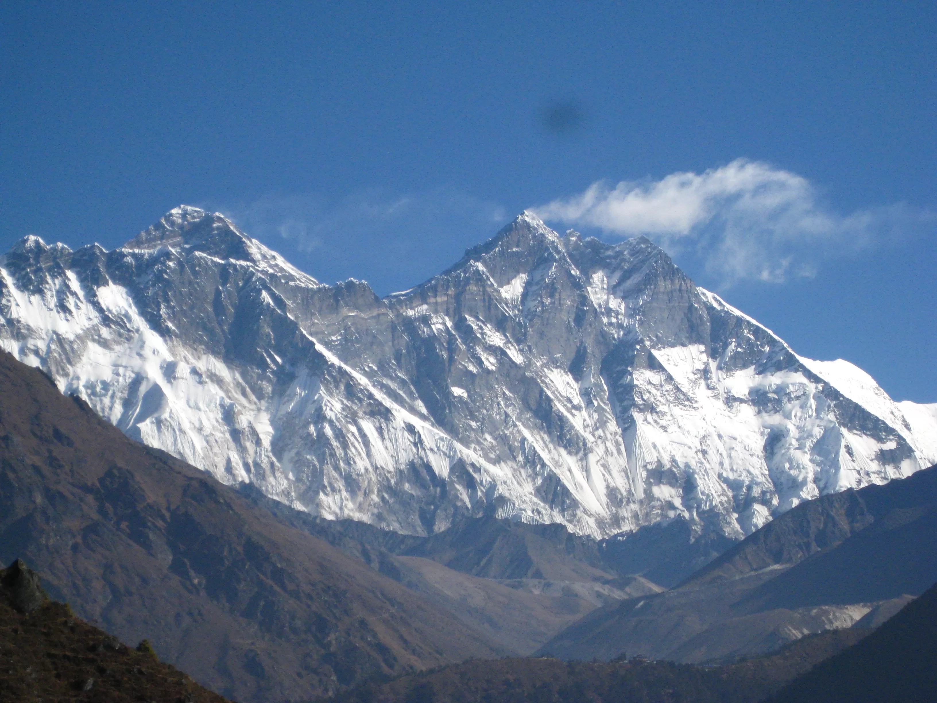 Everest seen from Nepal side with snow-covered peaks and blue sky in the background
