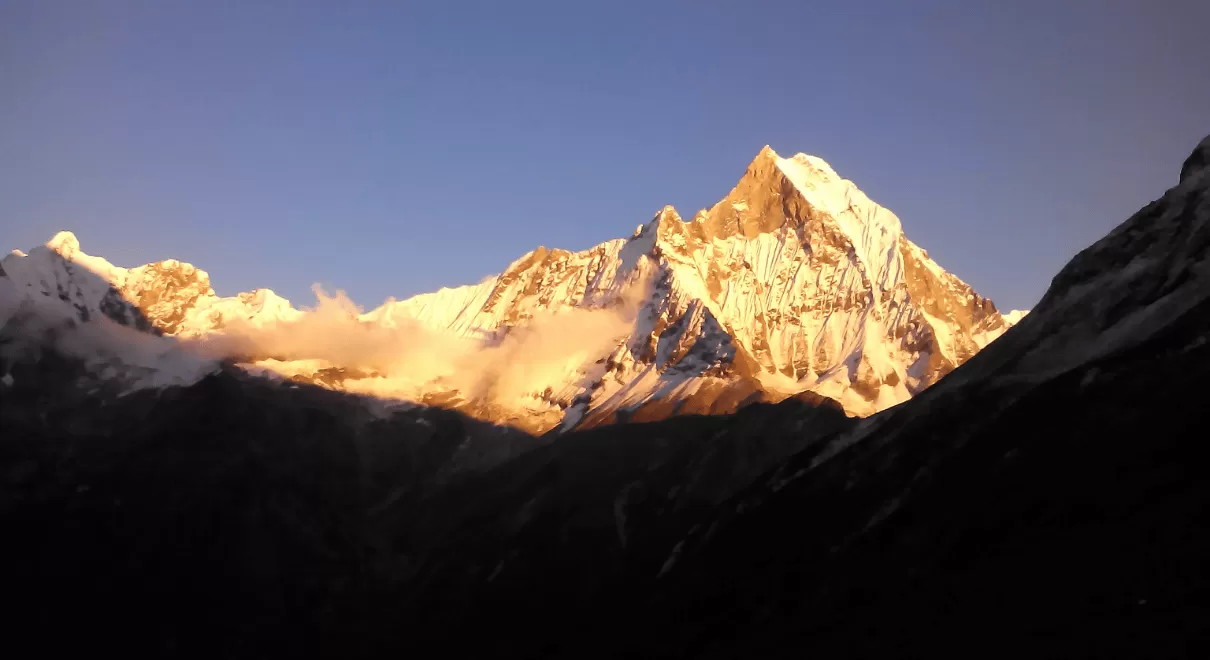 Trekking in Nepal information,Trekkers walking on mountain trail in Nepal Himalayas with snow-capped peaks