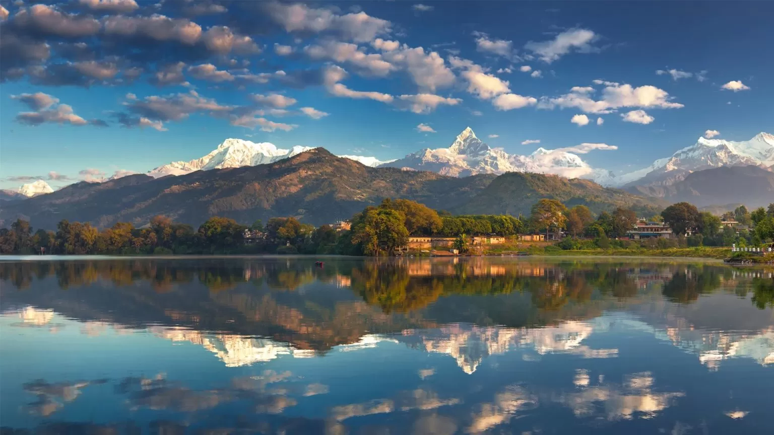 Which is the most beautiful place in Nepal - Pokhara lake reflecting Annapurna mountains with snow-capped peaks and serene waters