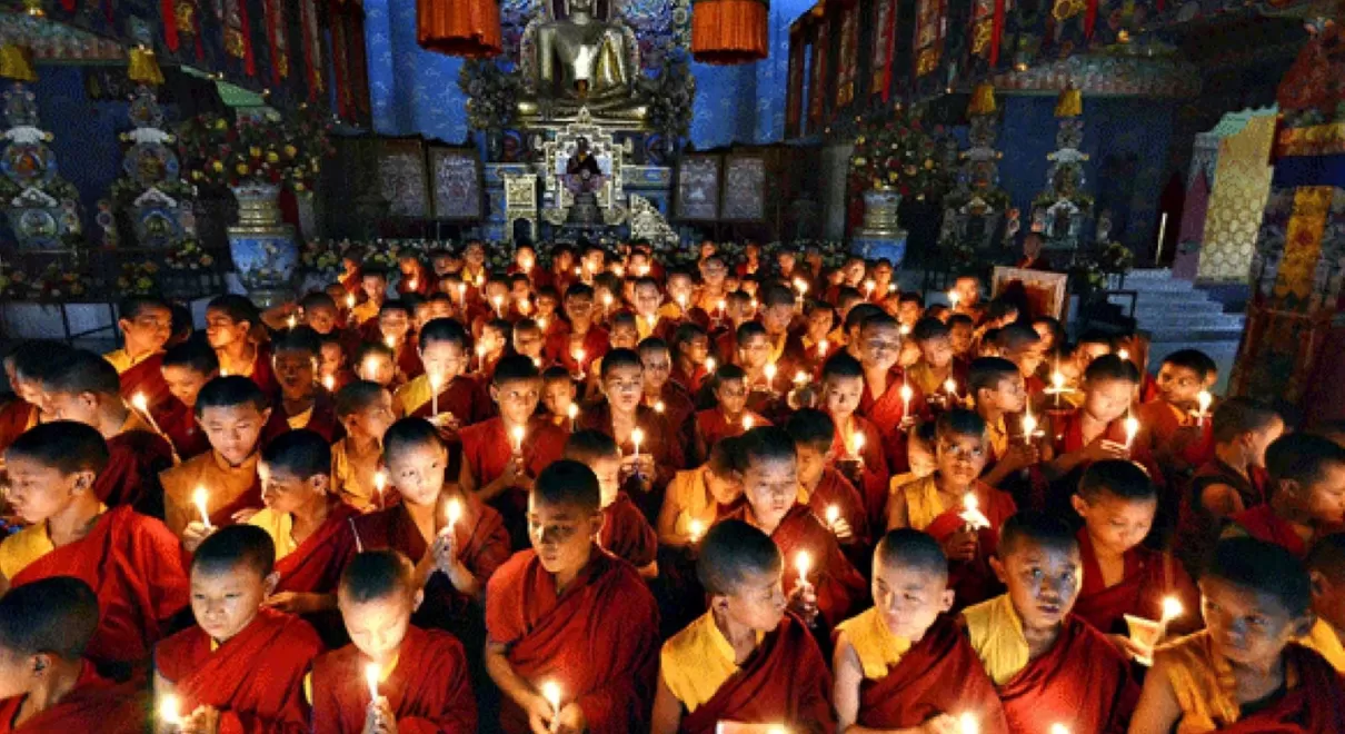 Buddhist pilgrimage tour group at sacred temple in Nepal