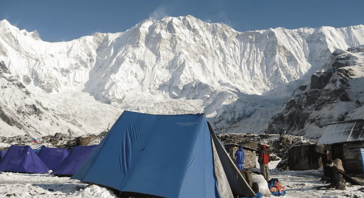 Trekker walking to Short Annapurna Base Camp surrounded by Himalayas
